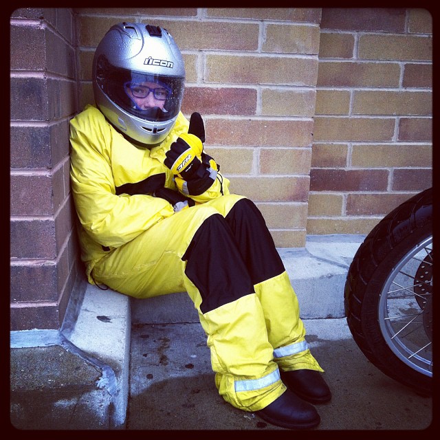 Holly "guarding" the bike and gear in the rain while Dad shops for essentials inside. #motorcycleformiracles #johnsonjourneys #toughkid